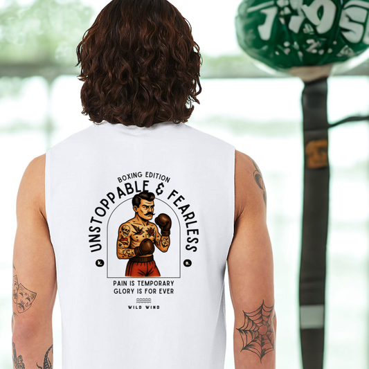 Person wearing a white sleeveless shirt with a boxing-themed design, standing in front of a blurred background.