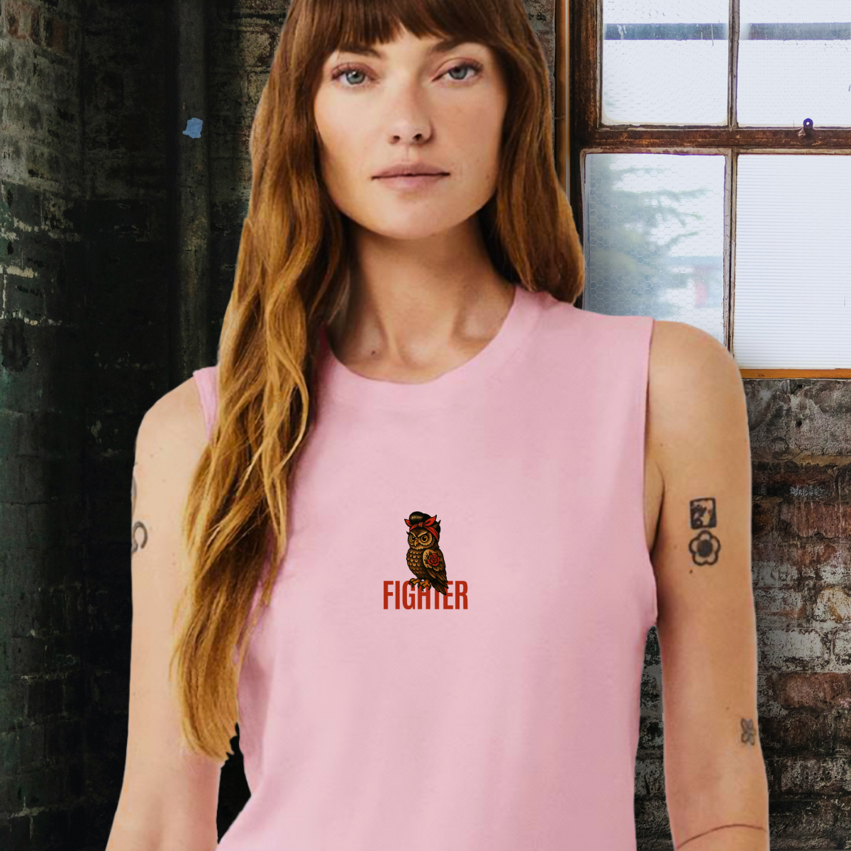 Woman wearing a pink sleeveless shirt with a figher owl.