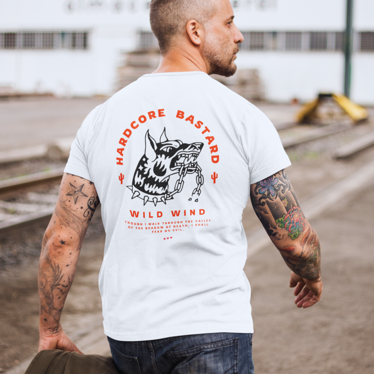 Man wearing a white t-shirt with graphic design and text outdoors