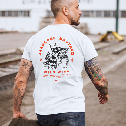 Man wearing a white t-shirt with graphic design and text outdoors