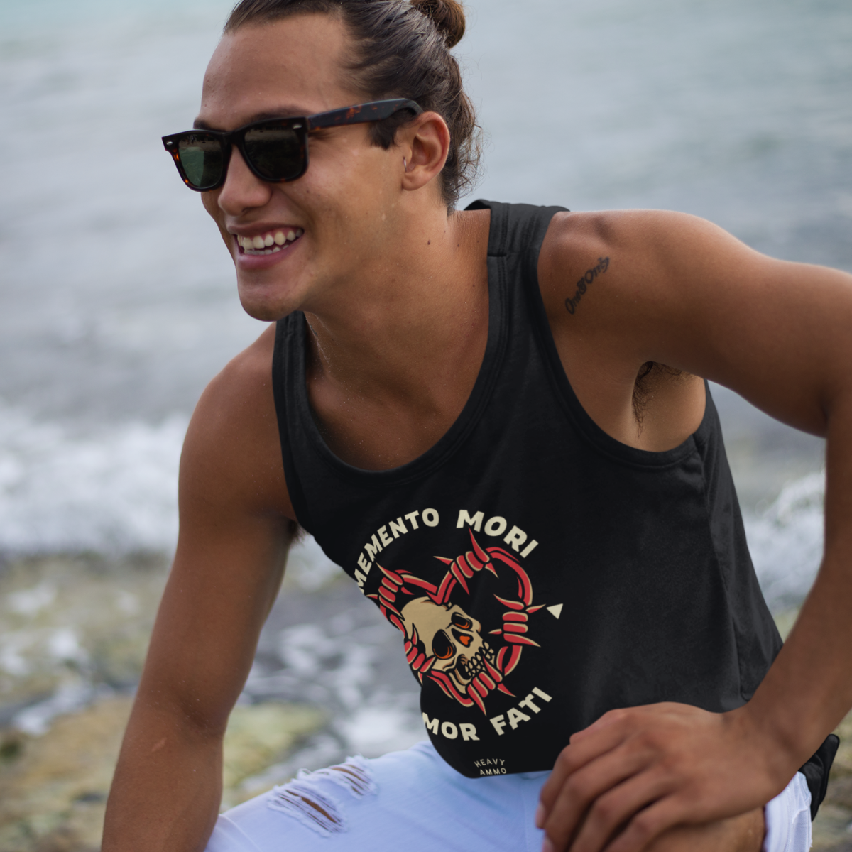 Man wearing a sblack tank top with a stoic tattoo inspired graphic design