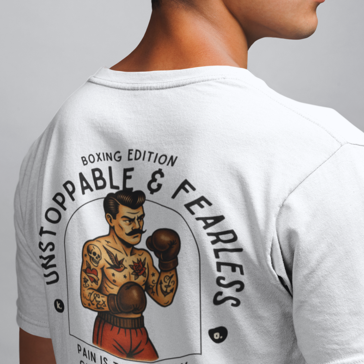White t-shirt with boxing-themed design and text on the back, worn by a person.